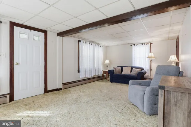an aerial view of a house with swimming pool and large trees