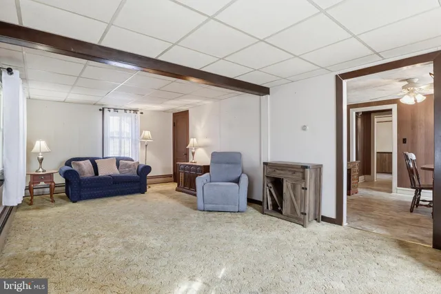 a view of a house with a yard and large tree