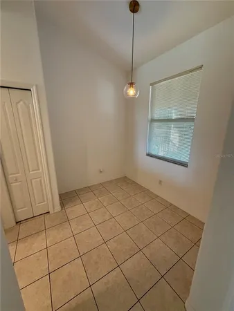 a view of an empty room and a window