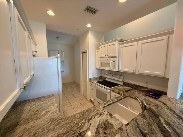 a living room with a bed furniture and a window