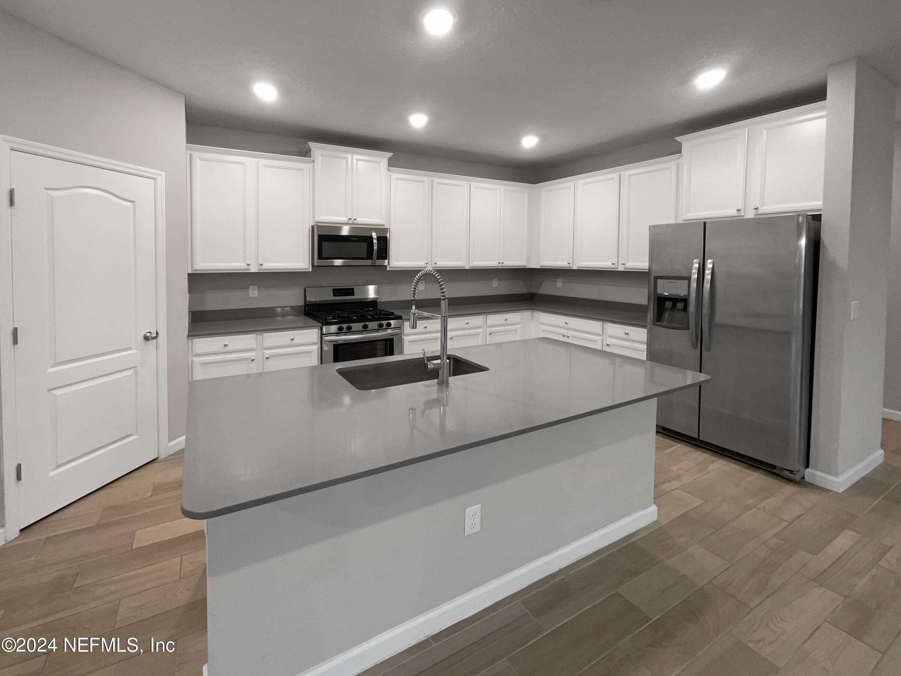 188 Bloomfield Way St. Augustine, FL 32092 - Photo 14 of 18 a kitchen with kitchen island a counter top space cabinets and stainless steel appliances