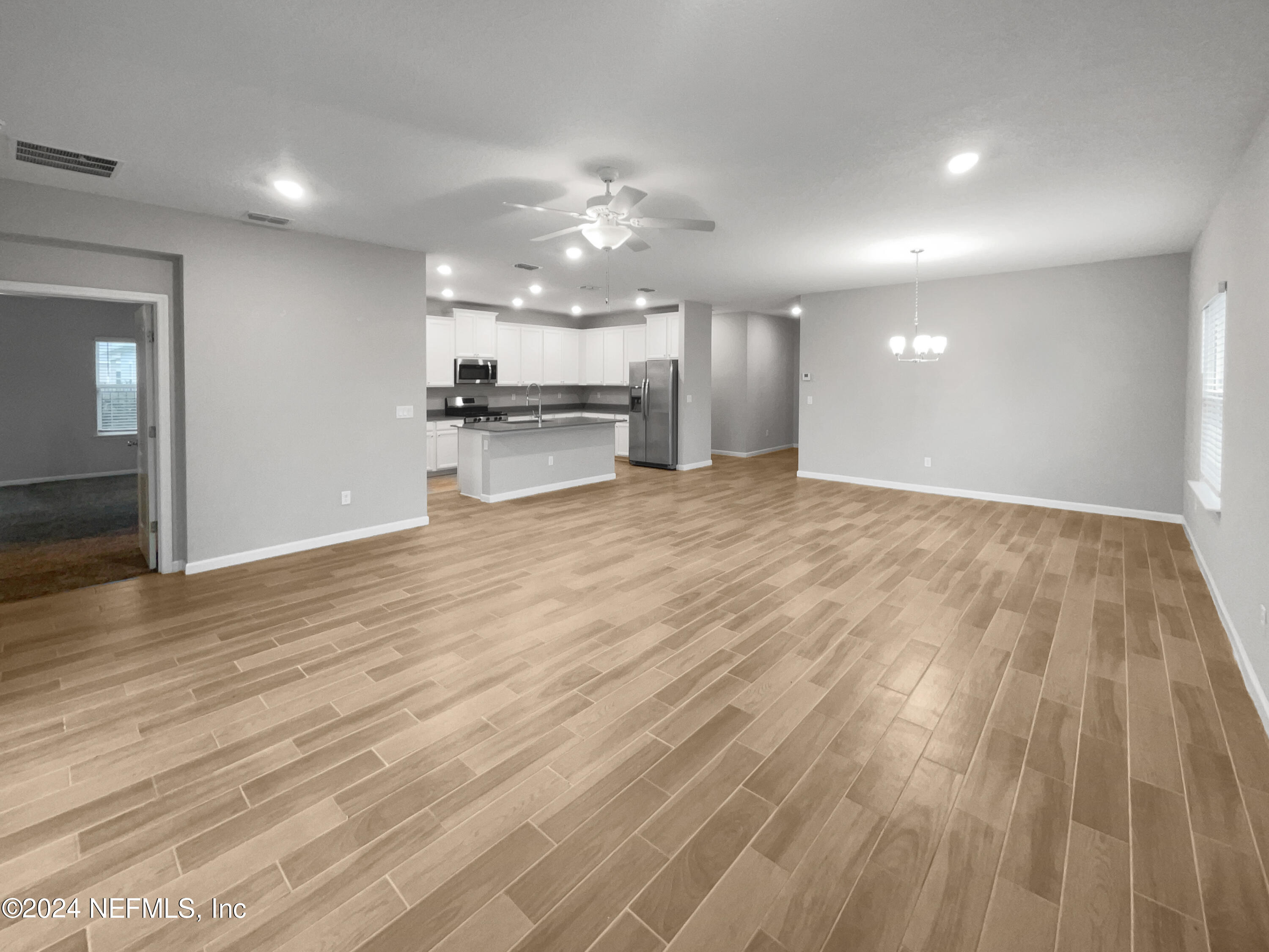 188 Bloomfield Way St. Augustine, FL 32092 - Photo 16 of 18 a view of a kitchen with kitchen island microwave and stove
