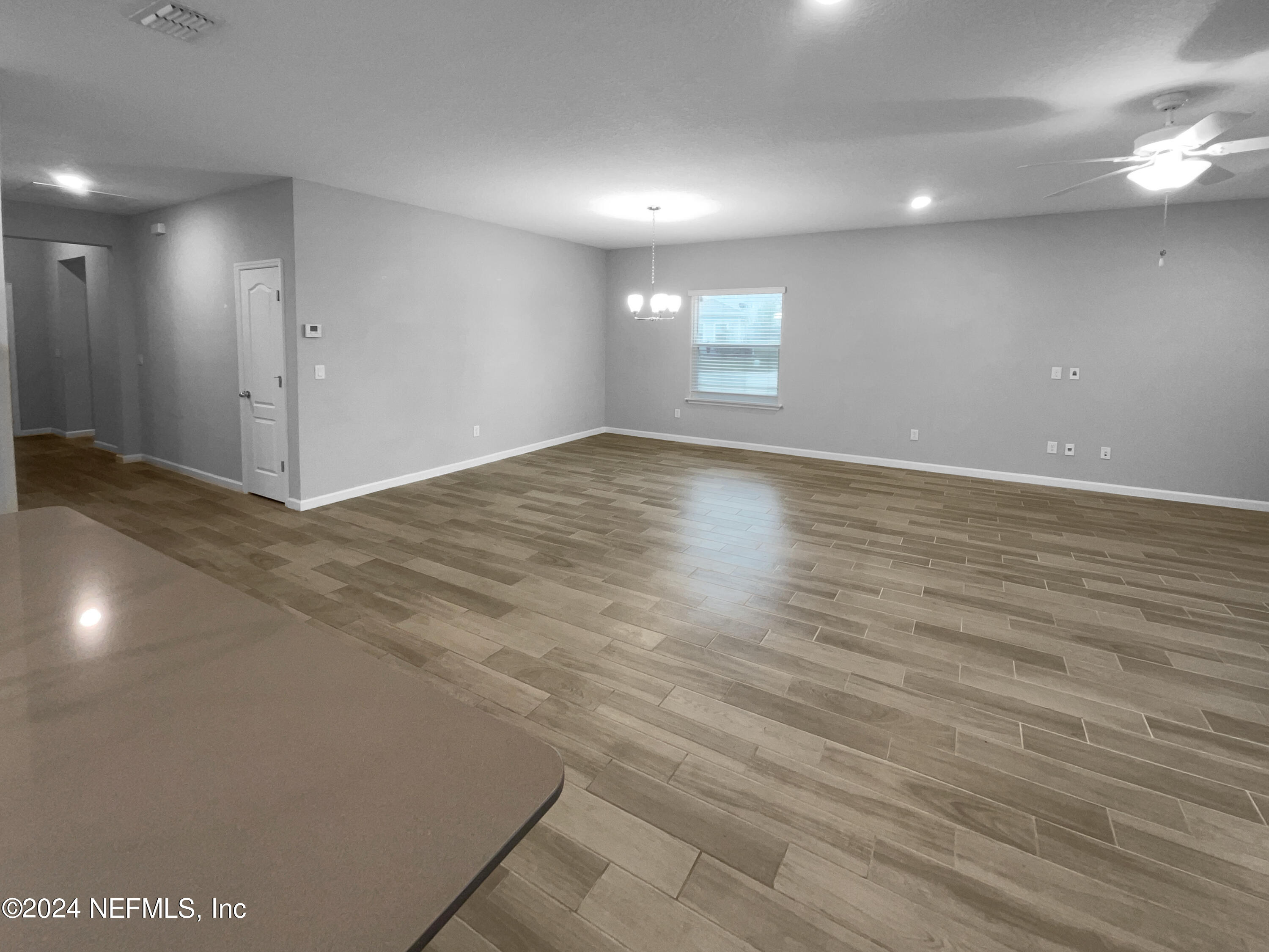 188 Bloomfield Way St. Augustine, FL 32092 - Photo 3 of 18 an empty room with wooden floor and windows