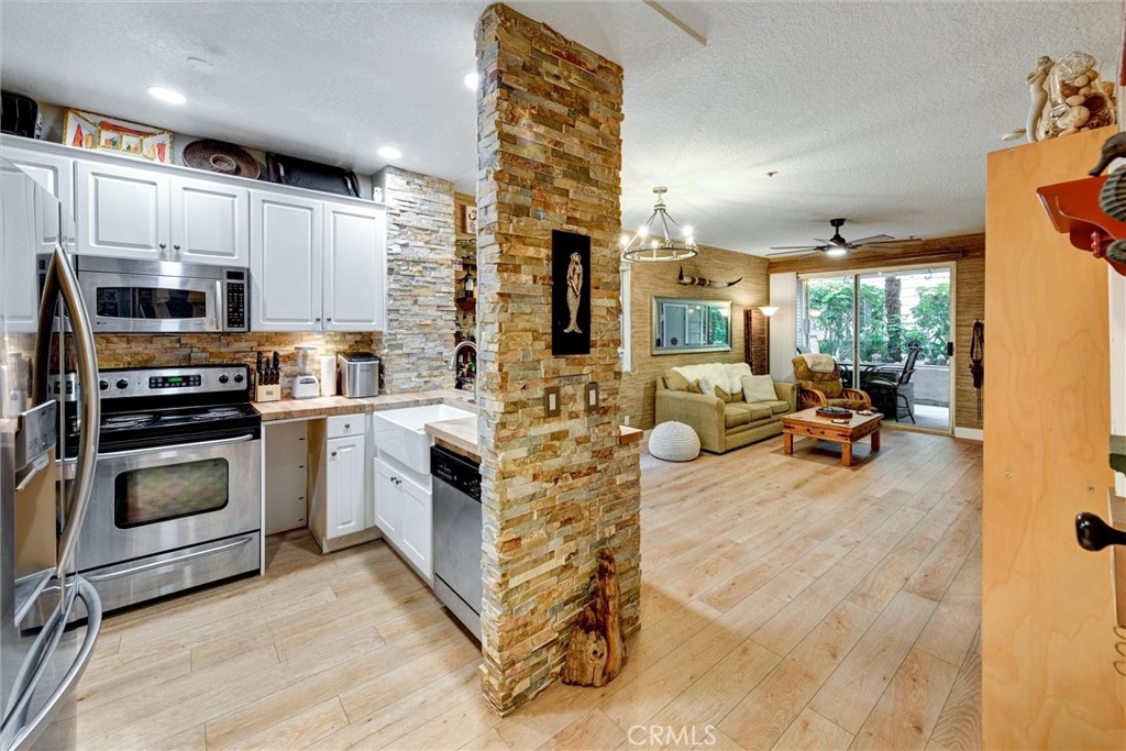 a kitchen with stainless steel appliances a stove a sink and a refrigerator