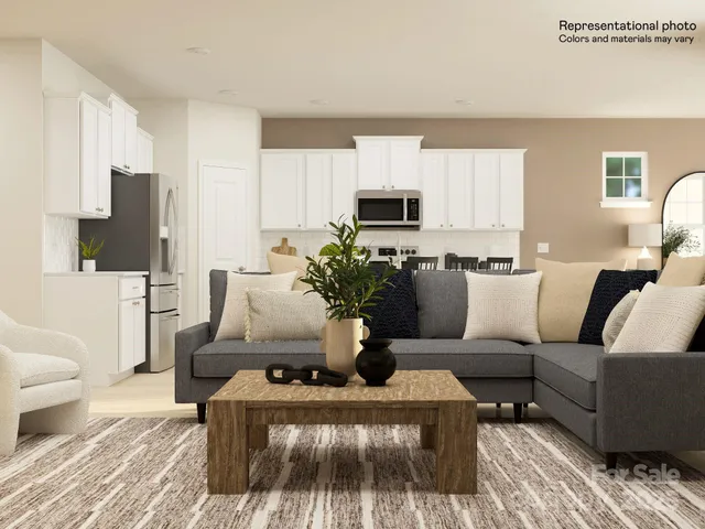 a living room with furniture a flat screen tv and a lamp