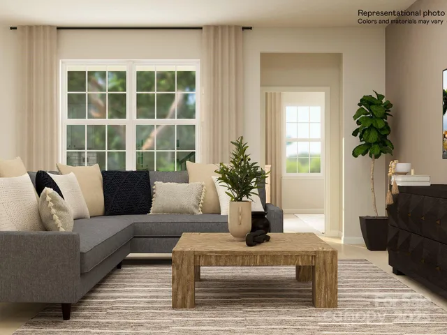 a living room with furniture potted plant and a window