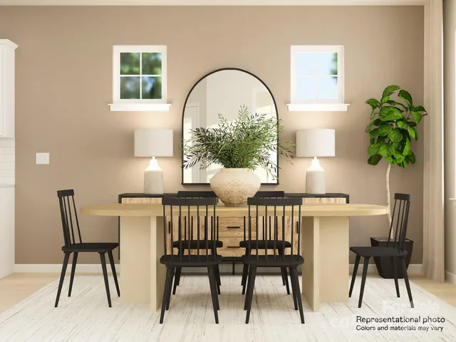 a view of a dining room with furniture and a potted plant