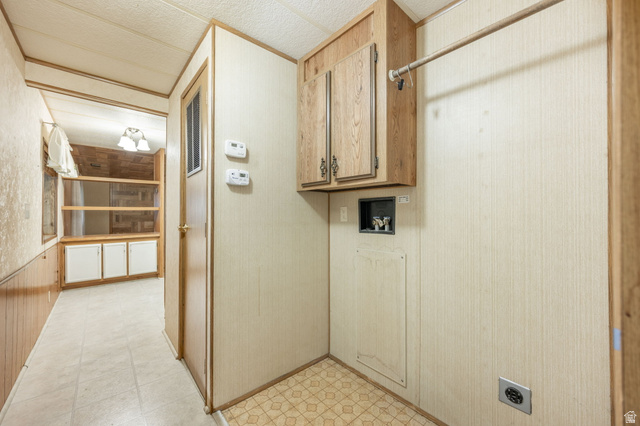1360 North Dixie Downs Road, Unit 4 St. George, UT 84770 - Photo 15 of 22 Dedicated laundry area featuring wood-finish cabinetry, a hanging rod, and a utility outlet