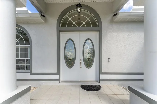 a living room with furniture a chandelier and a rug