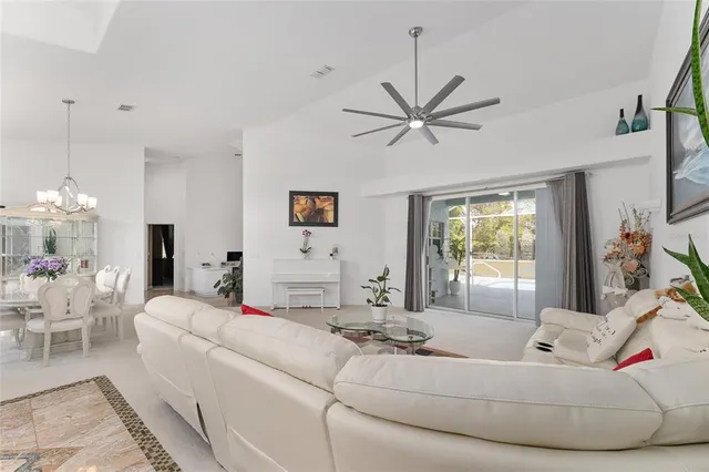 a view of a dining room with furniture and chandelier