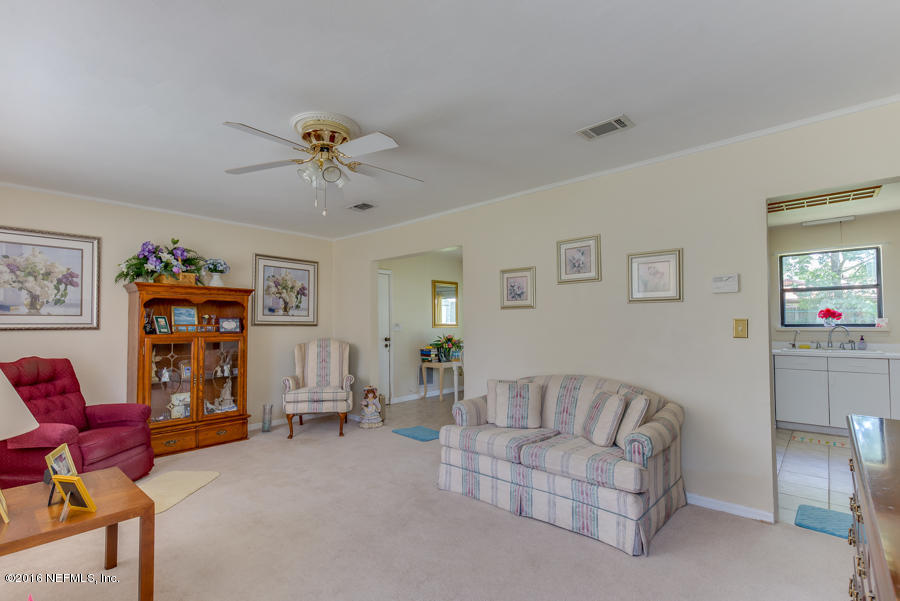 6615 Diane Road Jacksonville, FL 32277 - Photo 11 of 23 a living room with furniture and a chandelier