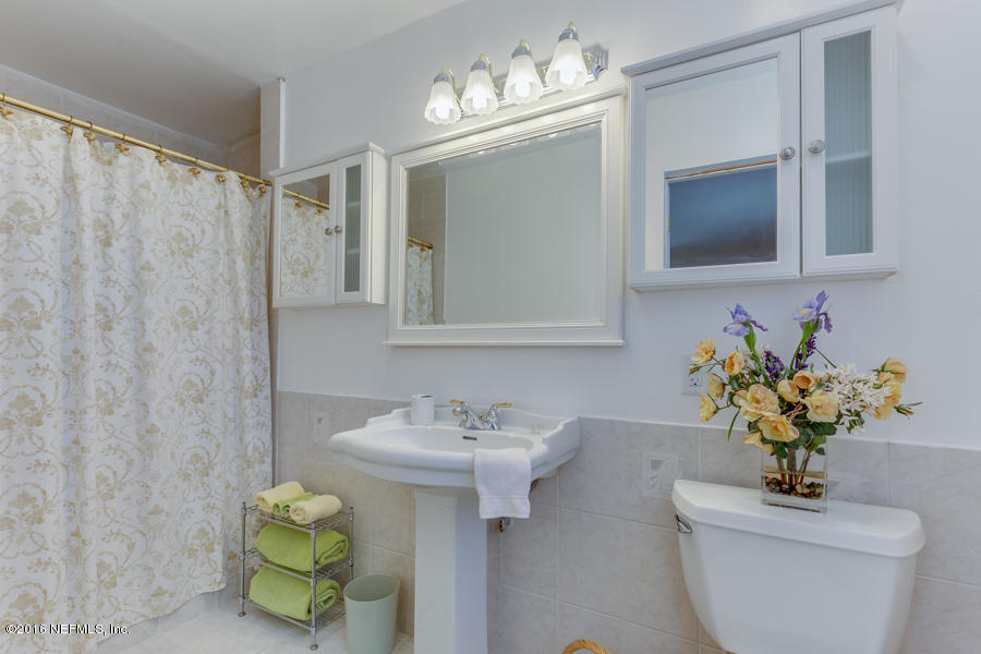 6615 Diane Road Jacksonville, FL 32277 - Photo 18 of 23 a bathroom with a sink toilet and shower
