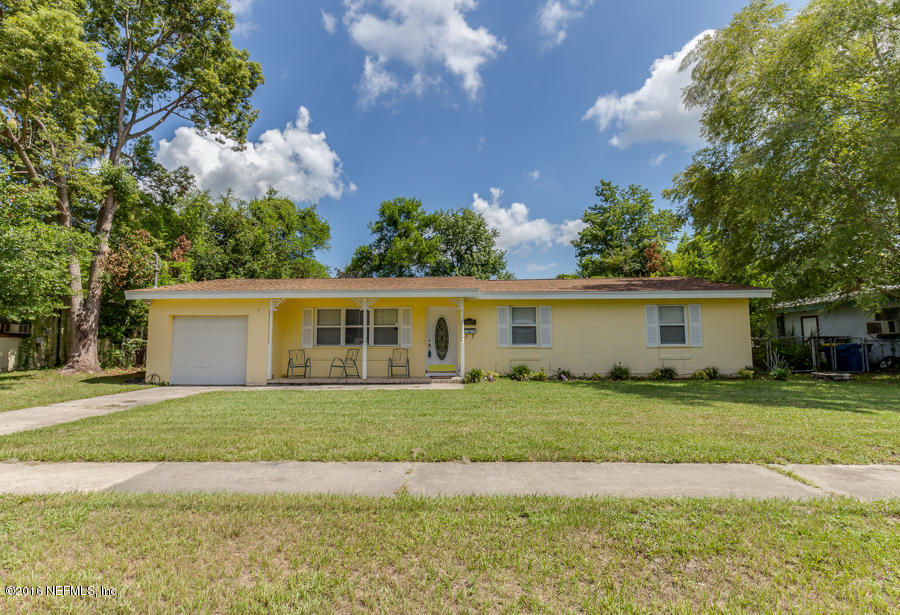 6615 Diane Road Jacksonville, FL 32277 - Photo 3 of 23 a front view of a house with a garden and trees