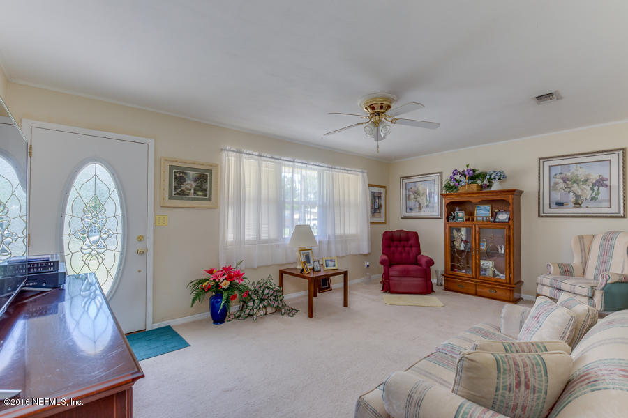 6615 Diane Road Jacksonville, FL 32277 - Photo 9 of 23 a view of a livingroom with furniture and a flat screen tv