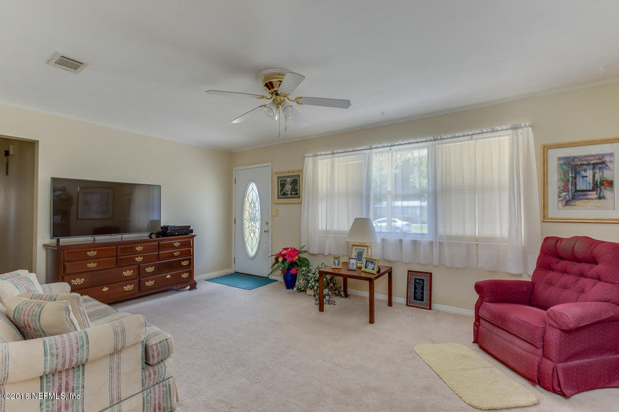 6615 Diane Road Jacksonville, FL 32277 - Photo 10 of 23 a living room with furniture and a flat screen tv