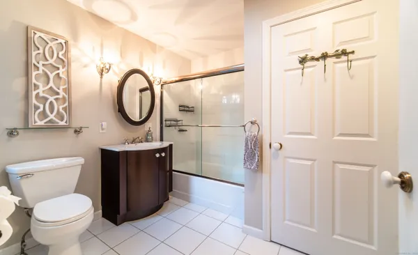 a bathroom with a toilet a sink and a shower