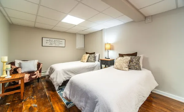 a bedroom with two beds and a lamp