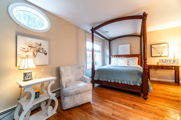a bedroom with a bed and a chandelier