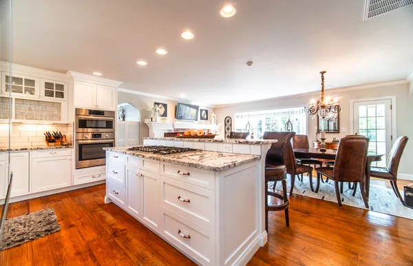a kitchen with stainless steel appliances granite countertop a stove and a refrigerator