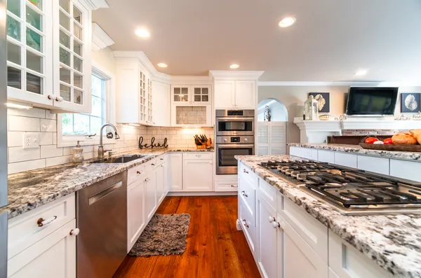 a kitchen with stainless steel appliances granite countertop a stove and a sink