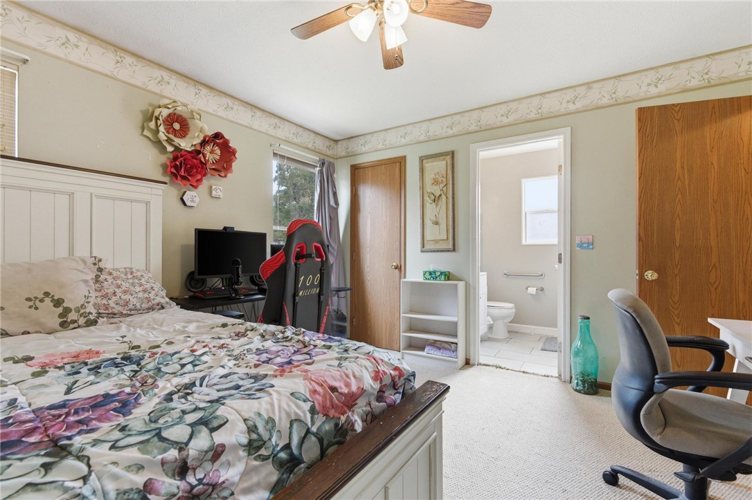 8747 Waynes Way Blanchester, OH 45107 - Photo 17 of 40 This cozy bedroom features carpeted flooring and a convenient attached bathroom.
