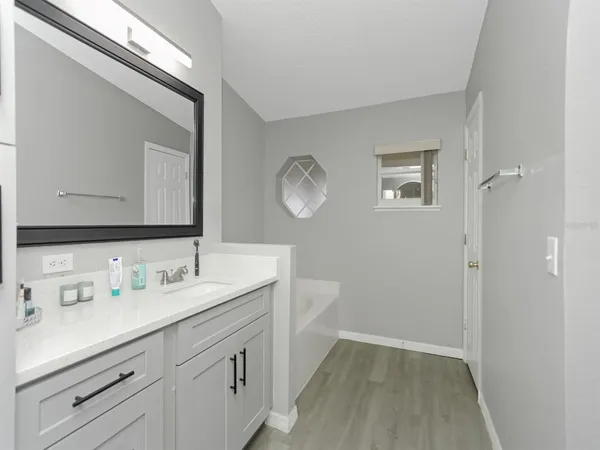 a spacious bathroom with a double vanity sink and a mirror