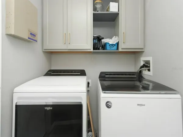 a view of kitchen cabinets and appliances