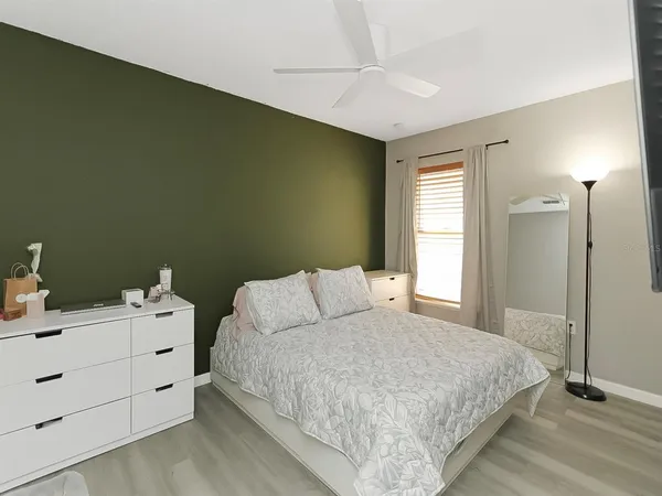 a bedroom with a bed and a dresser