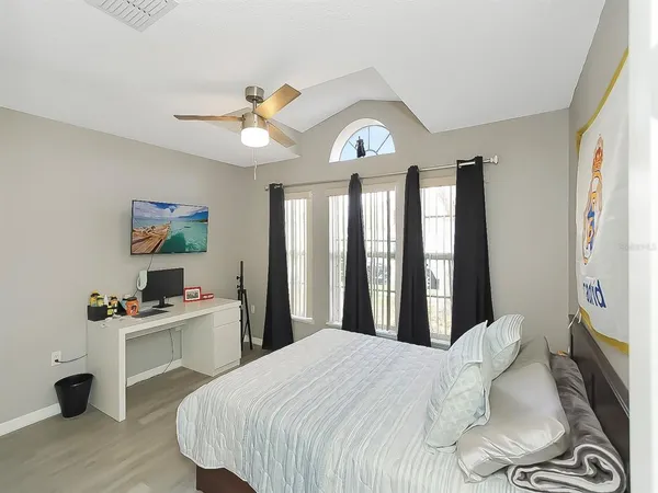 a bedroom with a bed and a desk