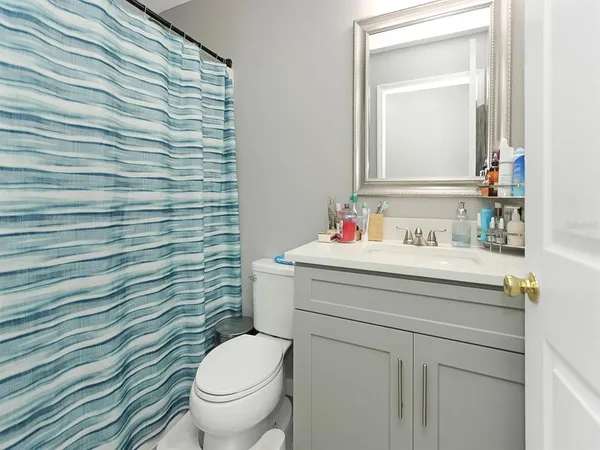 a bathroom with a sink toilet and mirror