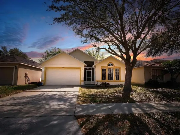 a front view of house with yard and trees