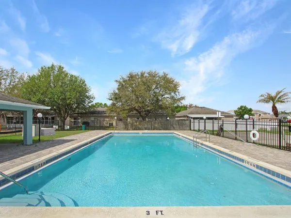 a view of a swimming pool with a yard