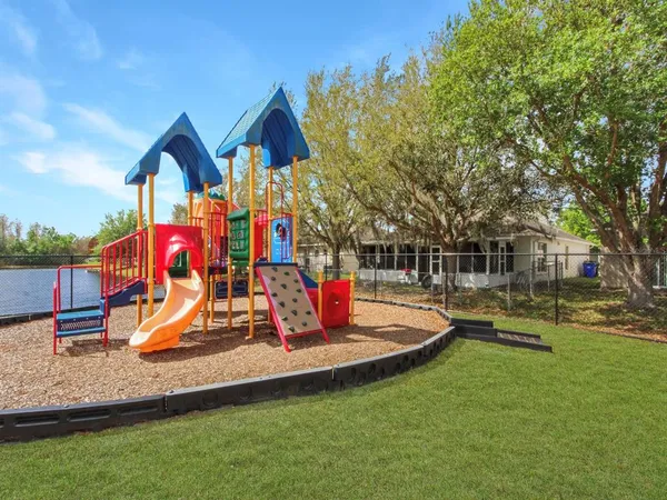 a view of playground with a slide and swing
