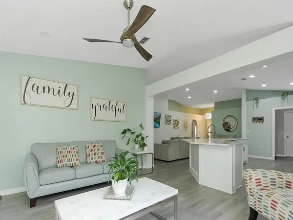 a living room with furniture and kitchen view