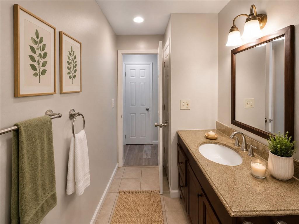 1280 Elizabeth Avenue Southwest Atlanta, GA 30310 - Photo 6 of 11 a bathroom with a granite countertop sink and a mirror