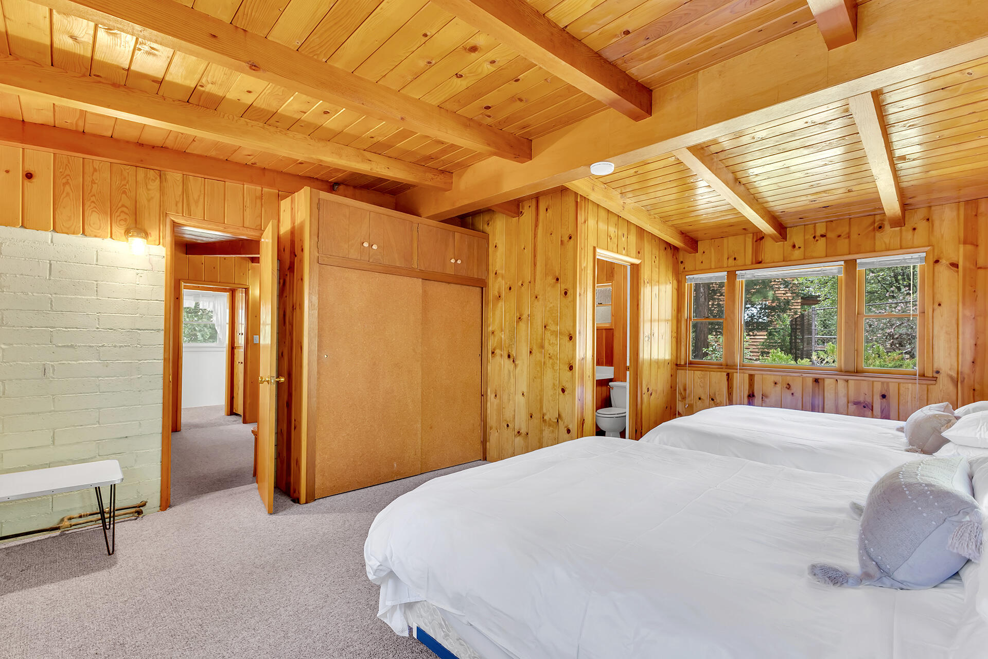 25270 Palomar Road Idyllwild, CA 92549 - Photo 30 of 60 a bedroom with a large bed and a chandelier