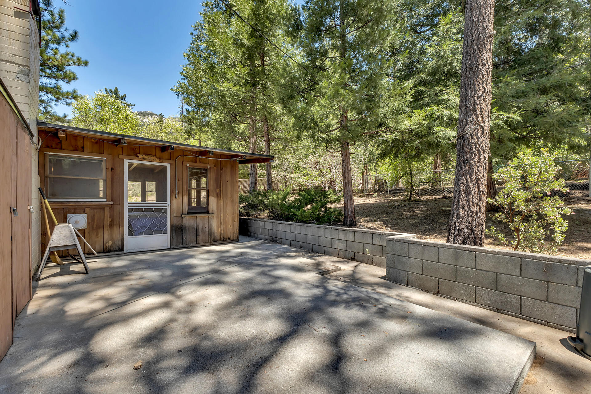 25270 Palomar Road Idyllwild, CA 92549 - Photo 40 of 60 a view of backyard with a large tree and wooden fence