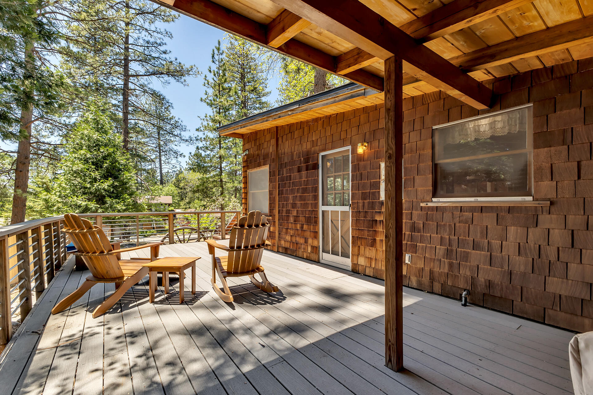 25270 Palomar Road Idyllwild, CA 92549 - Photo 49 of 60 a view of a chair and table in the patio with wooden floor