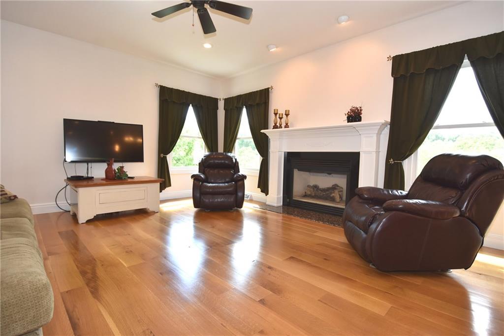 5050 East Willock Road Baldwin, PA 15236 - Photo 9 of 25 Family room with a lot of natural sunlight and gas fireplace
