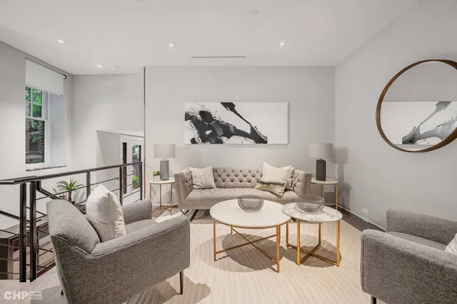 a living room with furniture a rug and a painting