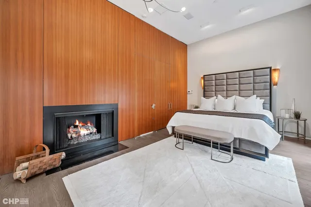a bedroom with a bed and a fireplace