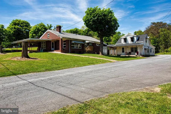 a front view of house with yard and green space