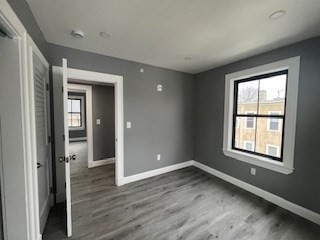 24 Judson Street, Unit 3 Boston, MA 02125 - Photo 11 of 18 wooden floor and windows in an empty room