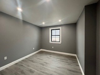24 Judson Street, Unit 3 Boston, MA 02125 - Photo 12 of 18 an empty room with wooden floor and windows