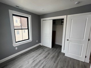 24 Judson Street, Unit 3 Boston, MA 02125 - Photo 15 of 18 an empty room with wooden floor and windows