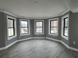 24 Judson Street, Unit 3 Boston, MA 02125 - Photo 2 of 18 a view of an empty room with wooden floor and a window