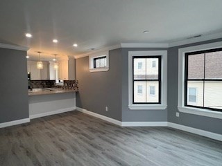 24 Judson Street, Unit 3 Boston, MA 02125 - Photo 3 of 18 a view of an empty room with window and wooden floor