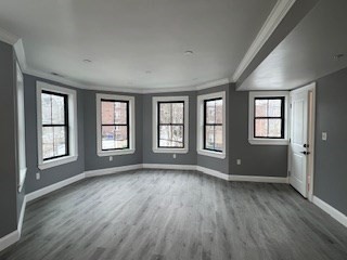24 Judson Street, Unit 3 Boston, MA 02125 - Photo 6 of 18 an empty room with wooden floor and windows