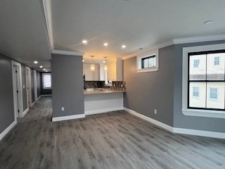 24 Judson Street, Unit 3 Boston, MA 02125 - Photo 10 of 18 a view of an empty room with wooden floor and a window