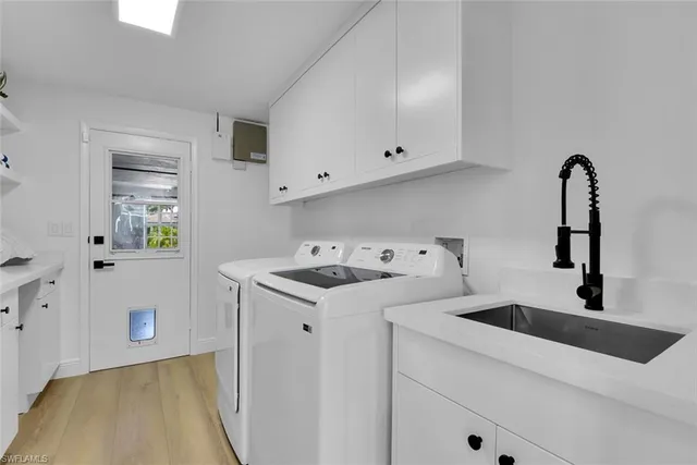 a view of a kitchen with sink stove and hallway